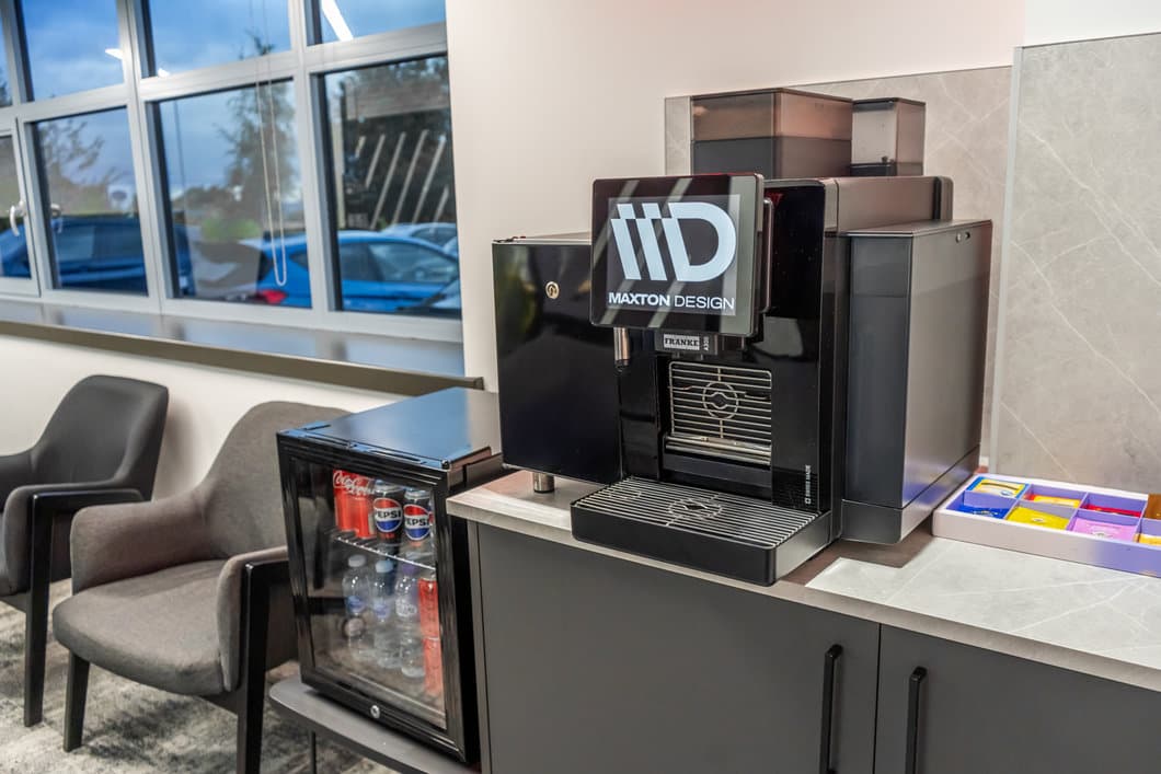 Maxton Design customer lounge with branded coffee machine and drinks fridge