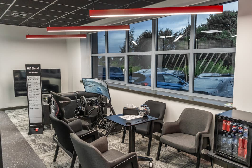 Maxton Design customer waiting area with sim racing setup and fastest lap leaderboard