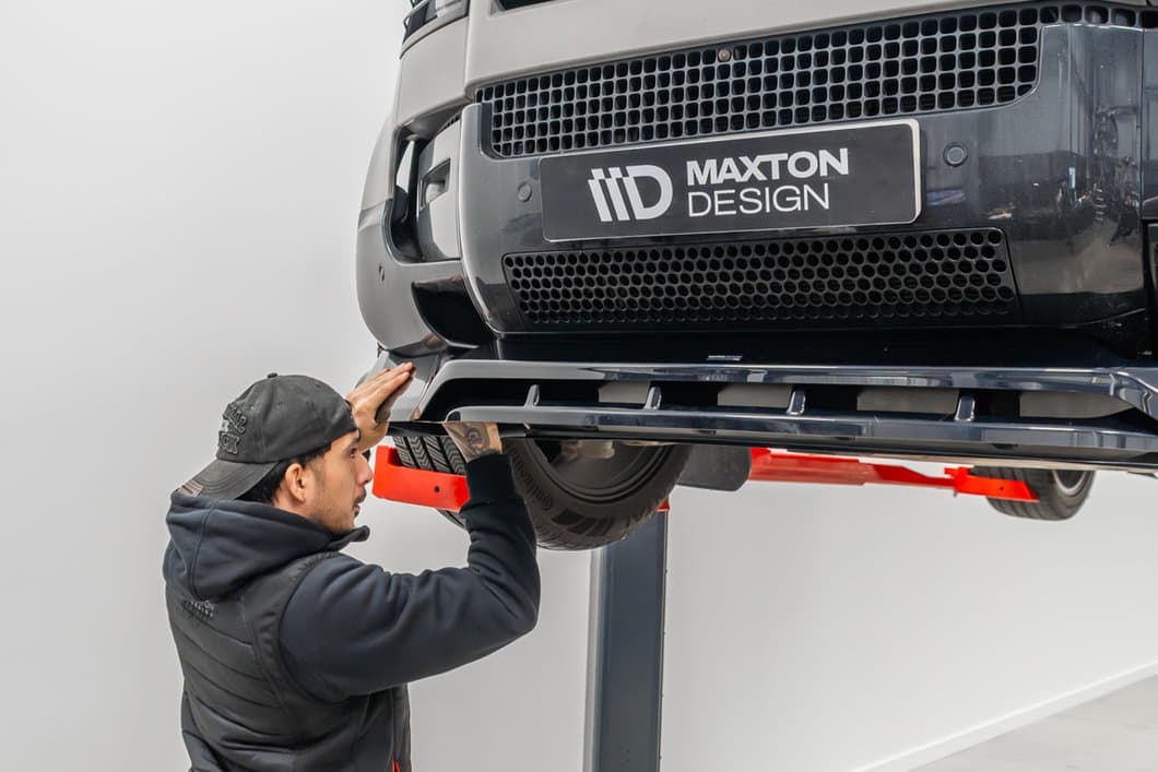 Maxton Design technician fitting a front splitter on a car lift