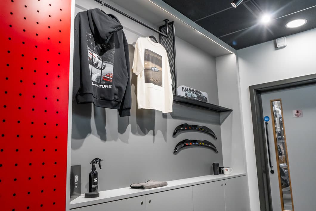 Maxton Design reception merchandise display with hoodies, t-shirts and body kit samples