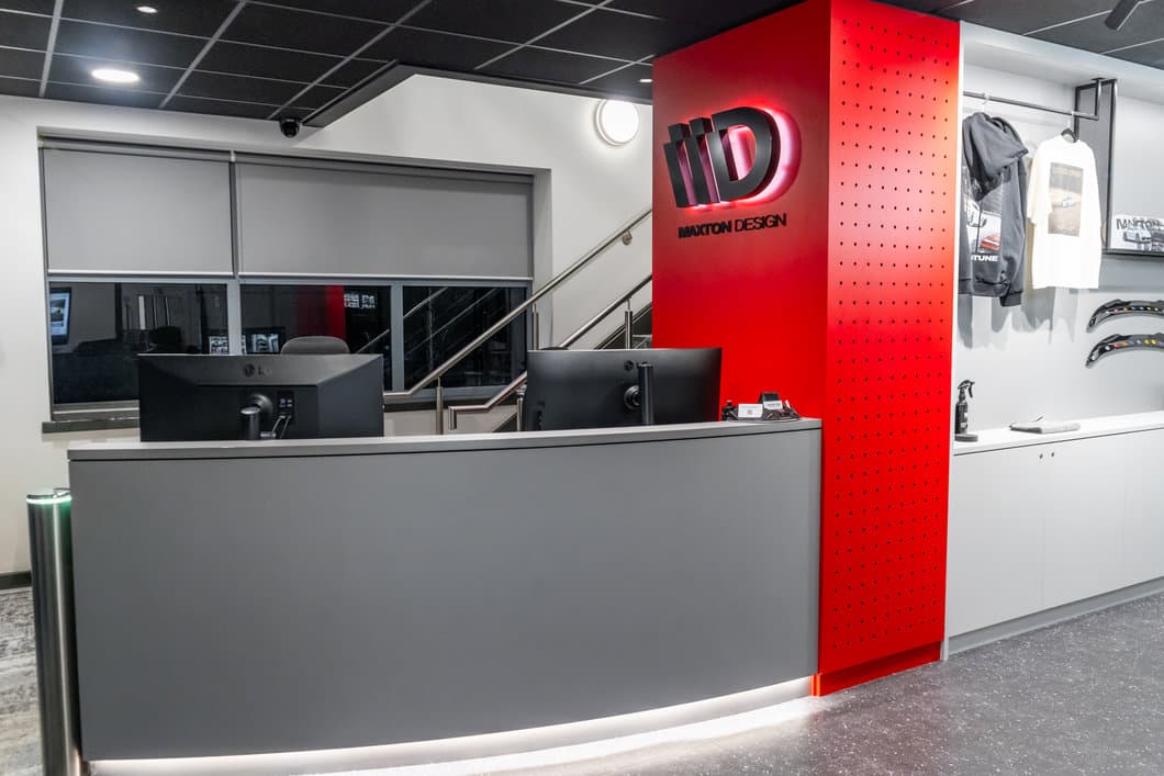 Maxton Design UK reception desk with branded logo and merchandise display